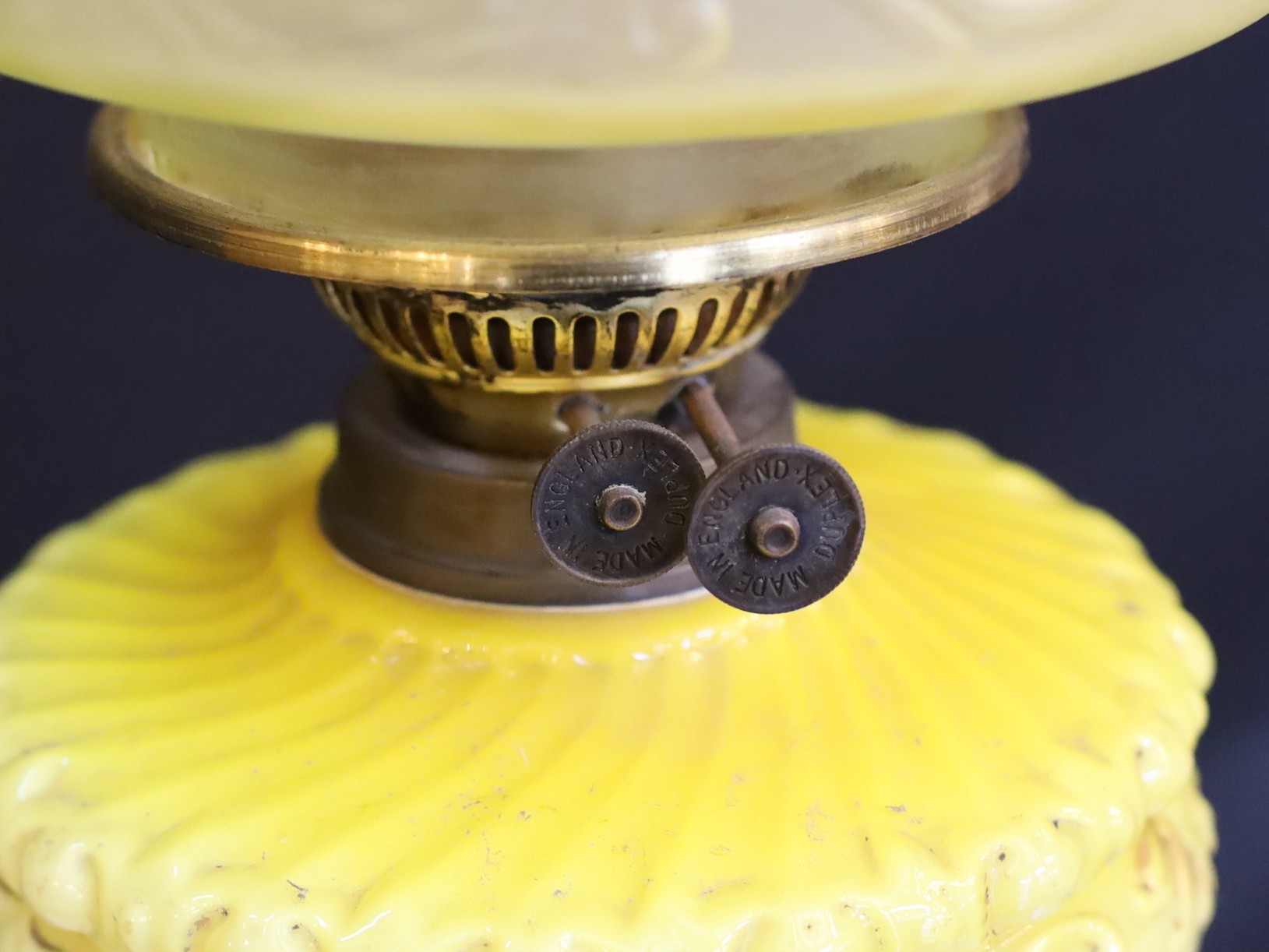 A Victorian brass oil lamp with opaque yellow glass reservoir, duplex mechanism, etched glass globe and flue, height overall 72cm